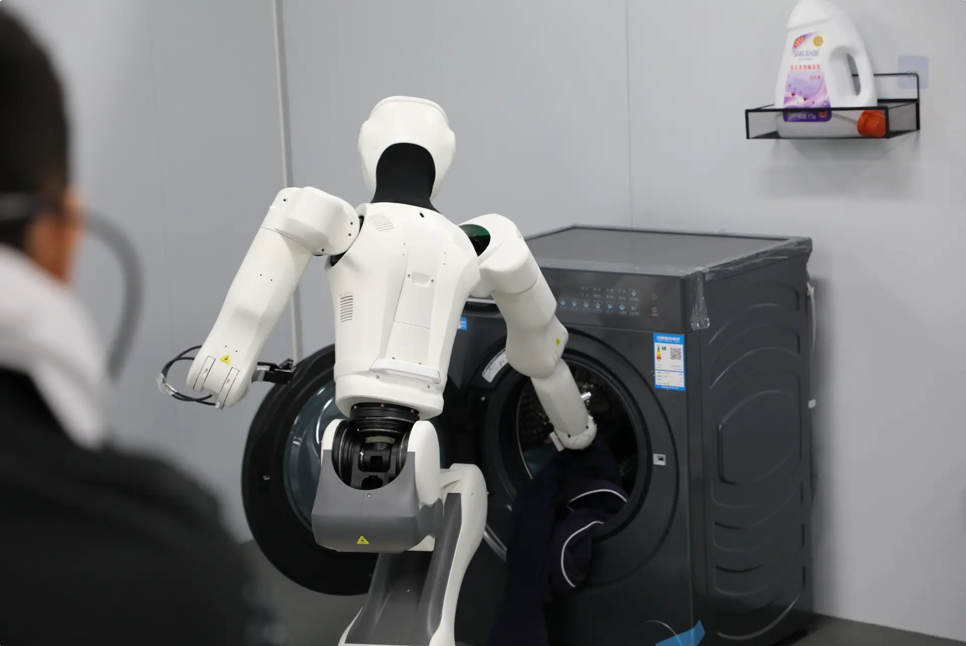 Person guiding a humanoid robot through a real-world task
